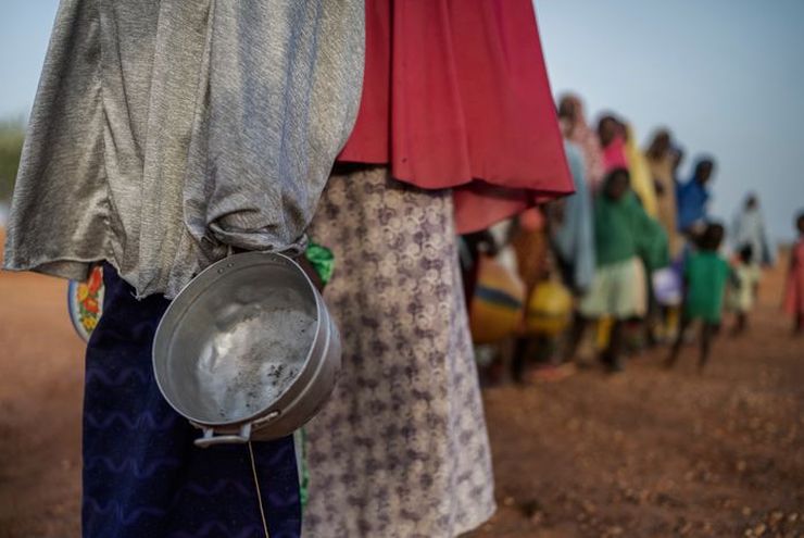 Africa hungry people stand in line for food support.