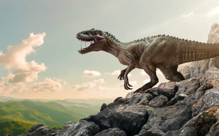 An illustration of a dinosaur Tyrannosaurus Rex On Top Of a Mountain Rock with a grey sky over its big head, looking down on the green valley, its skin is brownish green, 2 back legs are big, and 2 front legs are small with sharp claws. His mouth opens wide showing big sharp teeth and red tonge.