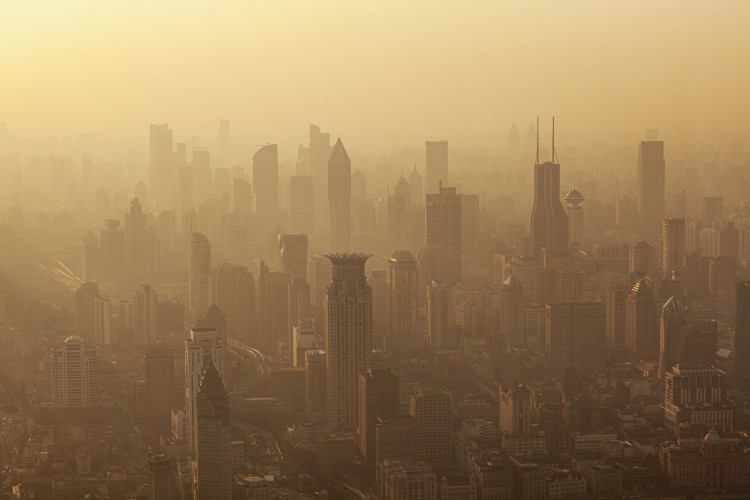 Air pollution seen over Shanghai's Puxi District buildings at dusk, China. Grey, liked smoky sky.