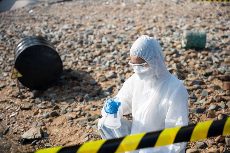 Ecologist sampling water from river with test tube glass and have white smoke, Biologist collects sample waste water from industrial of toxic chemicals, scientist environmentalist, problem environment