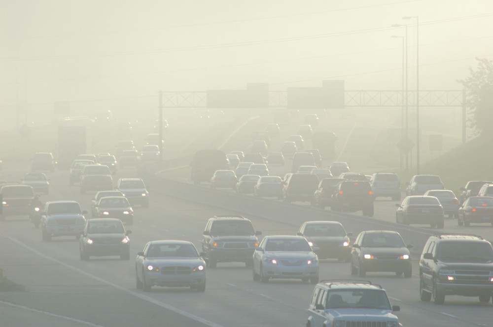 Cars at Rush Hour Driving Through Thick Smog.