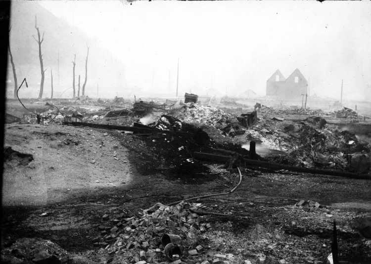 Completely fire devastated areas showing burned debris and denuded trees.