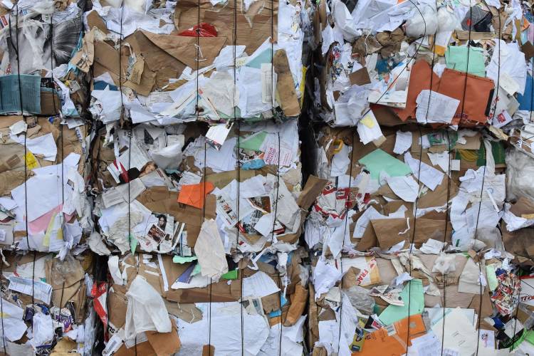 Big pile of paper bails and junk mails with coloful colors such as white, brown, green, pink, red, yellow...All tight with black strings.